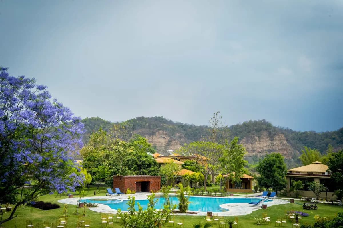 A wide view of the pool and gardens at Tarangi Resort