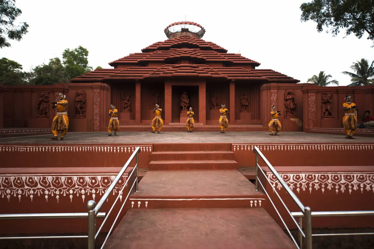 Gotipua dancers performing in front of a temple-style stage in Konark, Odisha