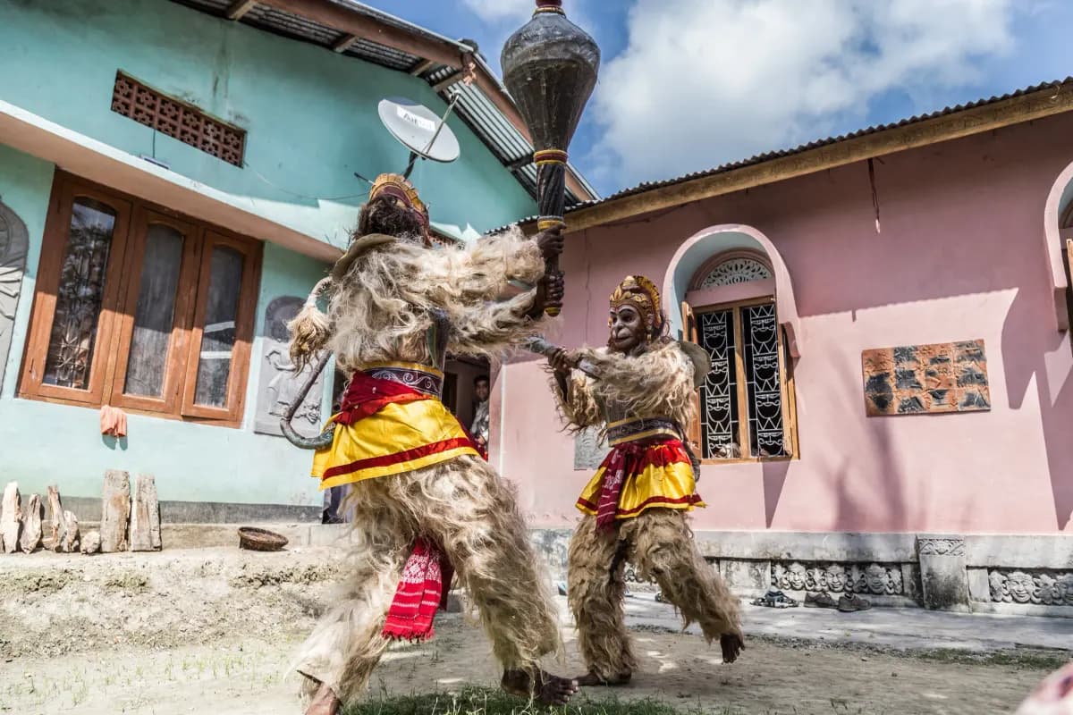Masked ritual dancers performing in a village courtyard in the mountains