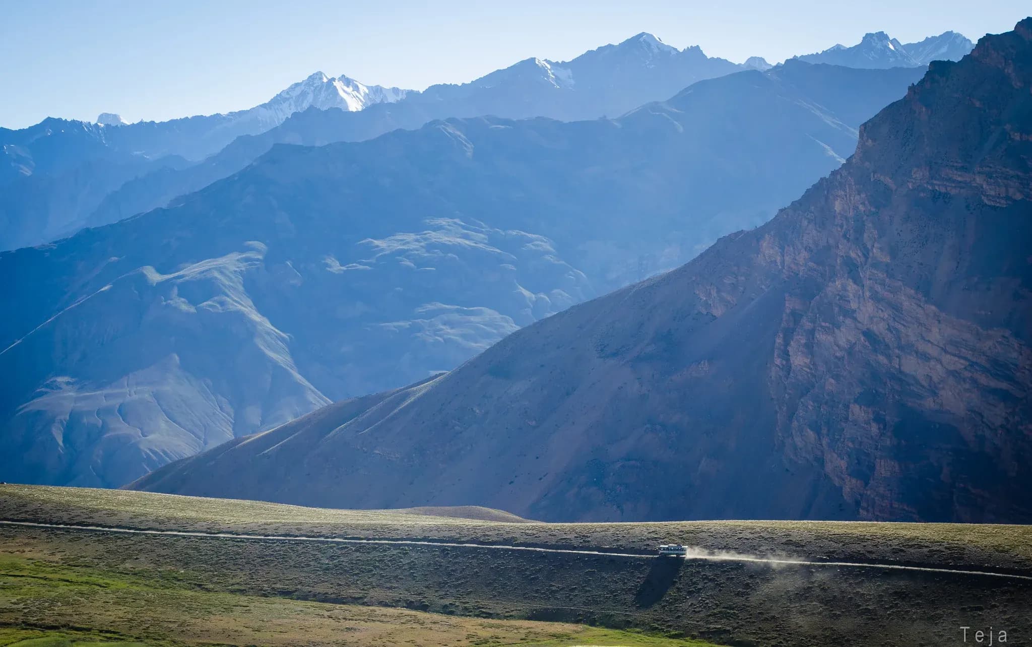 Two cars driving through the high mountain passes of Spiti valley