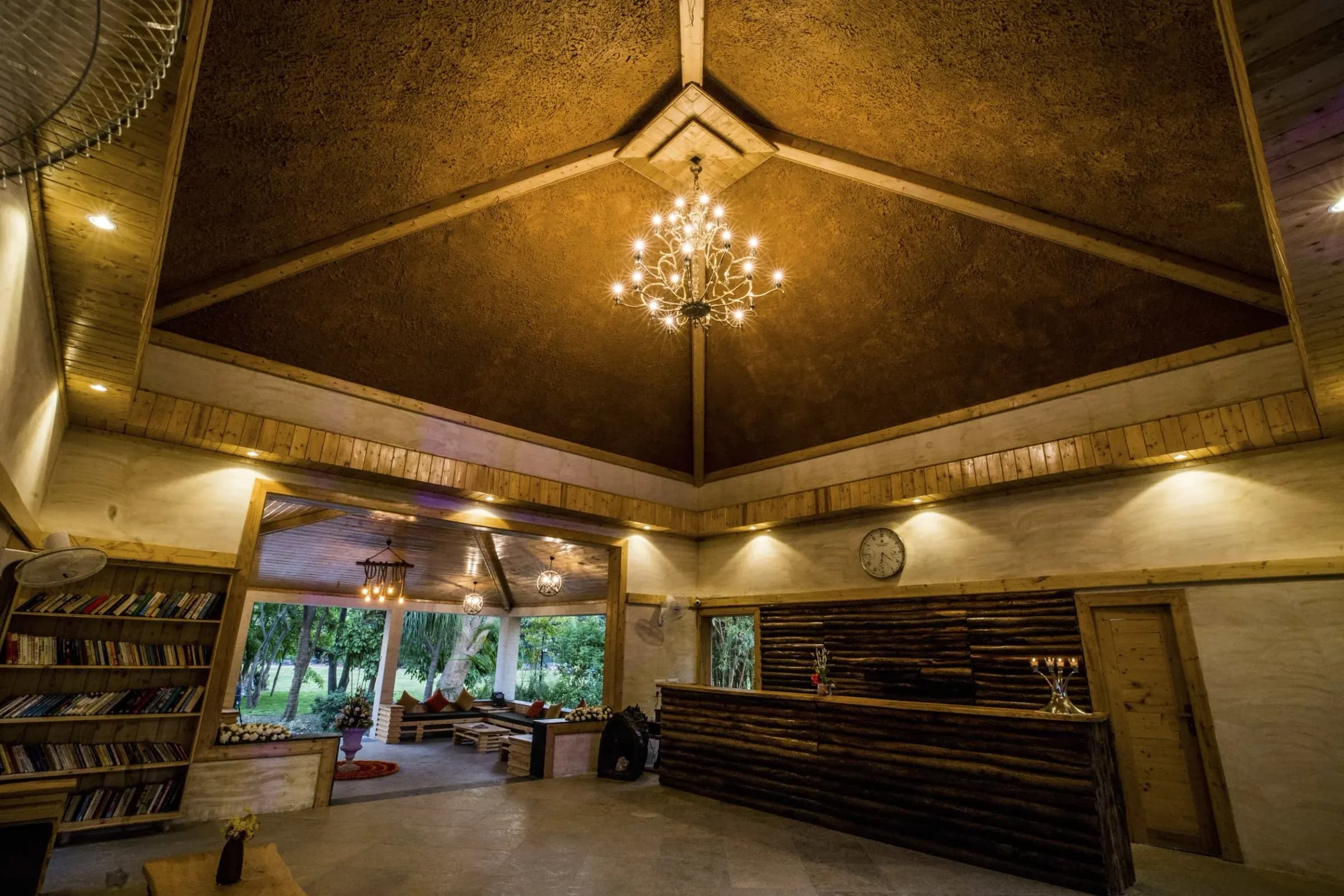 The lodge lounge at Tarangi Resort lit up in the evening, chandelier overhead